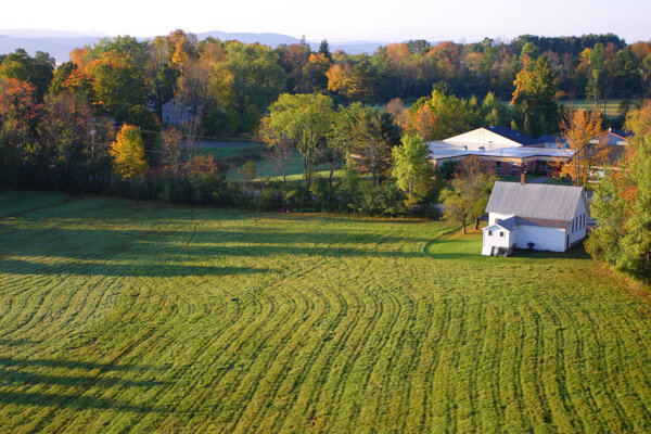 An aerial view of a hot air balloon floating over the Vermont countryside