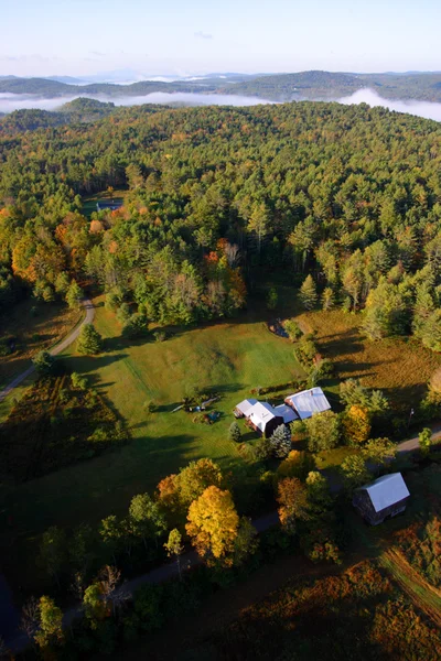 Uma vista aérea de um balão de ar quente flutuando sobre a paisagem de Vermont — Fotografia de Stock