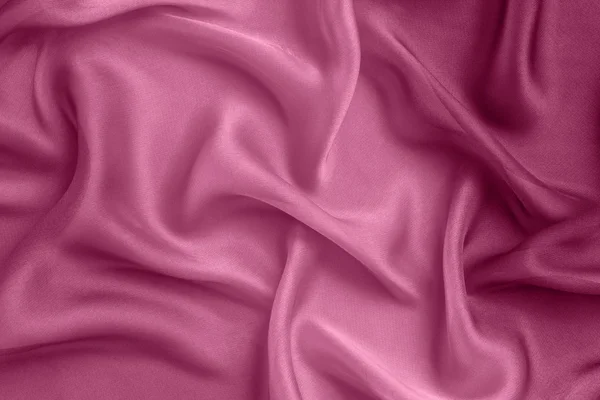 Fundo abstrato dobras tecido rosa — Fotografia de Stock