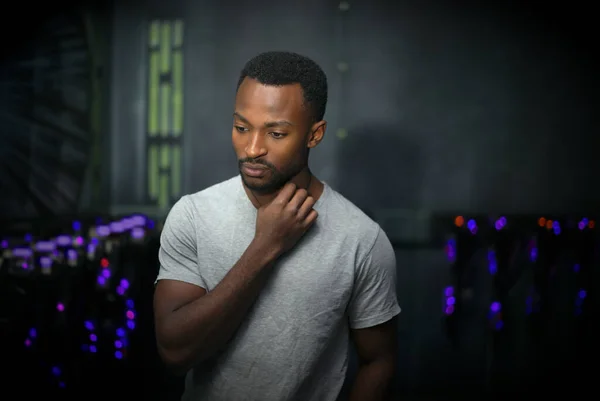 young thinking man wonder about future dark studio portrait