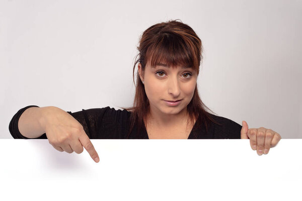 women holding and pointing white page presenting display panel