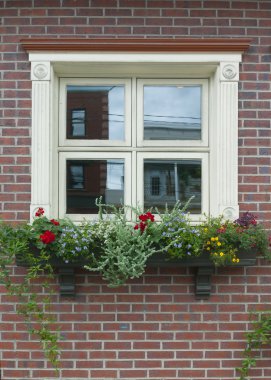 bir tuğla duvar üzerinde küçük soluk sarı kare pencere