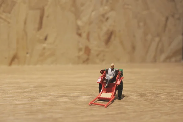 Estátua em miniatura e vermelho vintage oriental rickshaw táxi — Fotografia de Stock