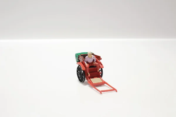 Estátua em miniatura e vermelho vintage oriental rickshaw táxi — Fotografia de Stock