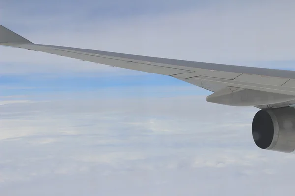 Airplane wing out of window — Stock Photo, Image