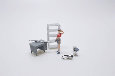 the mini figure of Female Mechanic is Working on a Car