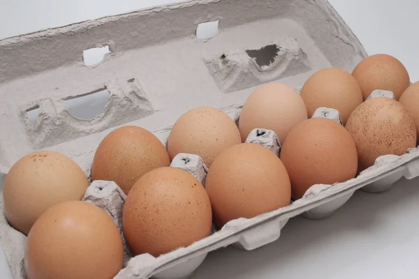 the Brown eggs in carton with white board