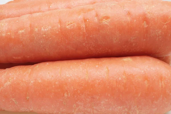 the close up of carrot on the white board