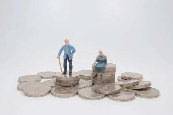 Mini People Elderly Sitting Stack Coins — Stockfoto