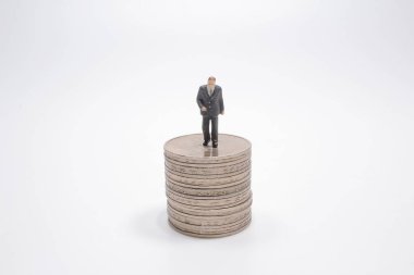 the mini of business figure And stack of coins