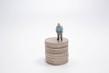the mini of business figure And stack of coins