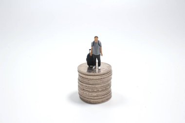 the mini travel figure stand on the coins 