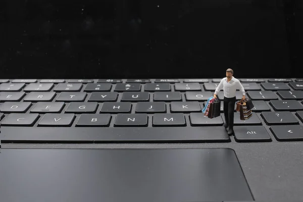 a mini of figure shopping online by Laptop