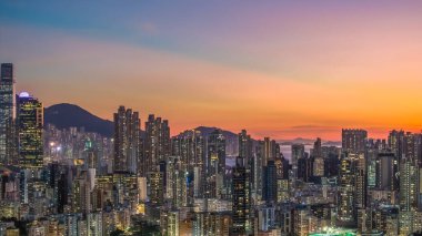 Evening cityscape with harbor lights and silhouettes