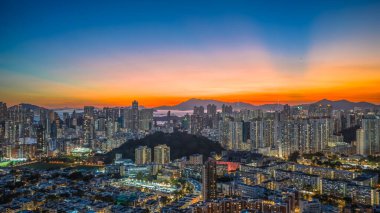 Evening cityscape with harbor lights and silhouettes