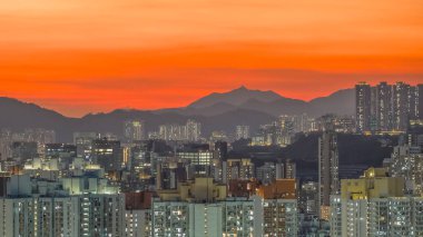 Evening cityscape with harbor lights and silhouettes