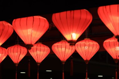 Vibrant red lanterns glow softly at night, creating a warm,