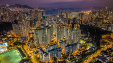 Public housing estate glowing under urban night lights