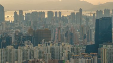 Yumuşak akşam parıltısı Kwun Tong binaları ve deniz manzaralı gökyüzü 11 Ocak 2026 'yı vurguluyor