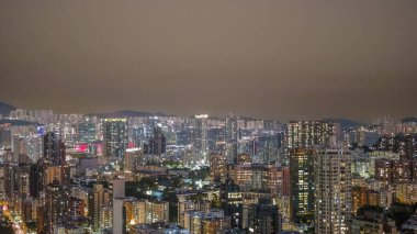 6 Şubat 2026 'da Kowloon caddelerinin üzerinde aydınlık kuleler yükseliyor.