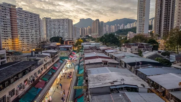 Tarihsel köy çatıları, 5 Şubat 2026 'da günbatımında modern kulelere tezat oluşturuyor.