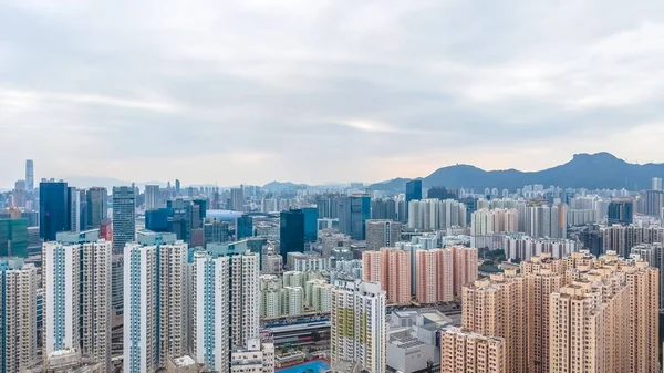 Yoğun yüksek katlı kümeler bulutlu gökyüzü altında şehir manzarası boyunca uzanır. 8 Şubat 2026