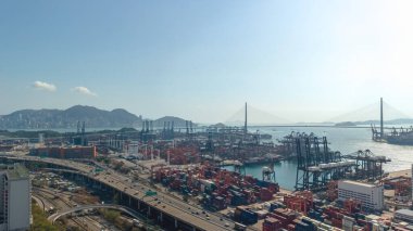 Geniş konteynır portu 16 Şubat 2026 'da ılık puslu akşam ışığı altında parlıyor.