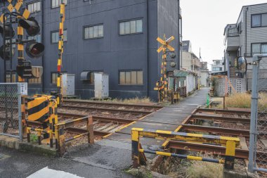 Urban train intersection with safety gates and local streets Nov 26 2025