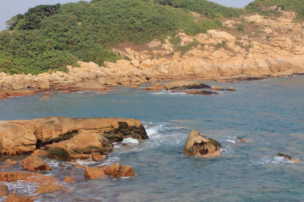 Rocky sea coast and blurred water in shek o — Stock Photo, Image