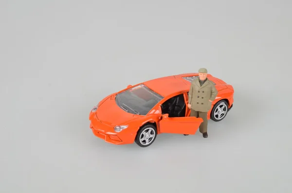 Carro de brinquedo plástico laranja isolado — Fotografia de Stock