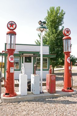 Antique Gas Pumps at an Old Filling Station clipart