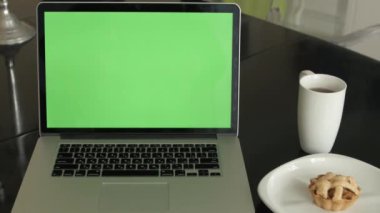 bir adam türleri masasının üzerindeki bir laptop.
