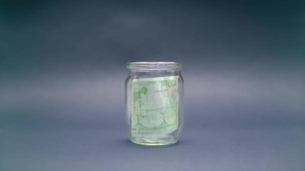 Woman Puts Euro 100 into a Glass Jar — Stock Video