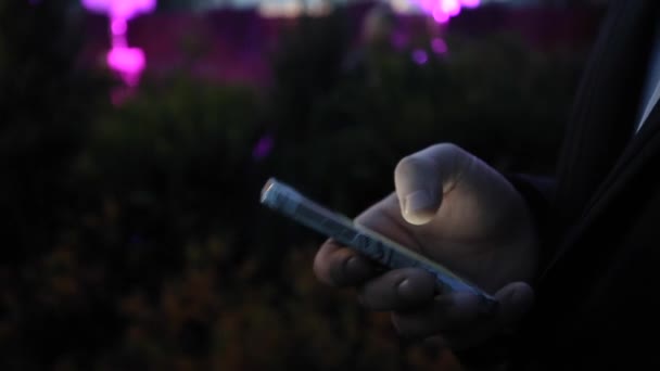 Man in the Jacket Using Phone at Evening — Stock Video