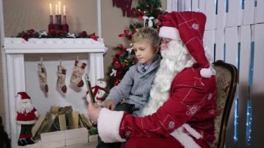 Küçük çocuk tablet Noel Baba hediye seçer
