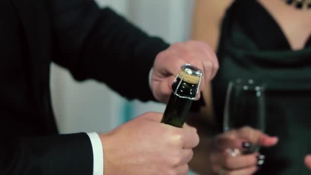 A Man in a Black Suit Uncorks The Bottle, The woman in black evening dress holding a glass — Stock Video