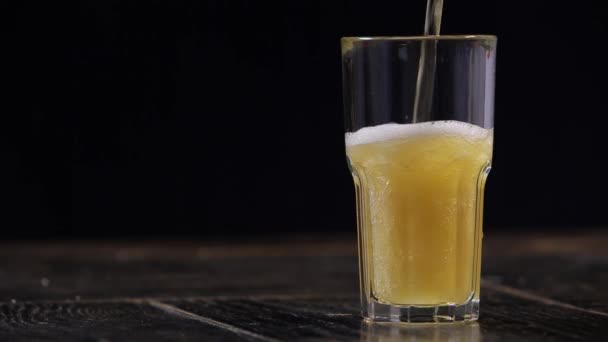 Beer Being Poured into glass, Black Background — Stock Video