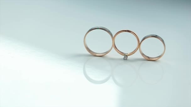 Gold Rings are on a White Background — Stock Video