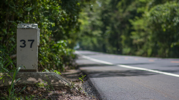 Милестолб или километровый камень на дороге
