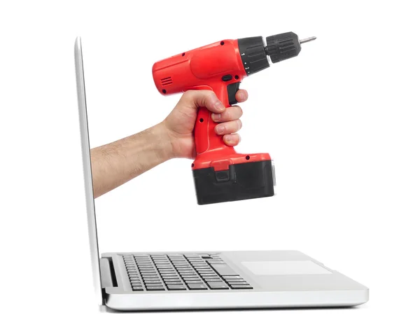 Hand with drill out of laptop — Stock Photo, Image