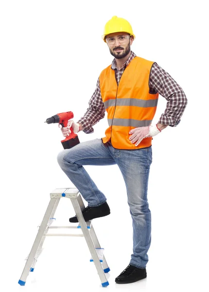 Carpinteiro com colete de segurança e broca — Fotografia de Stock