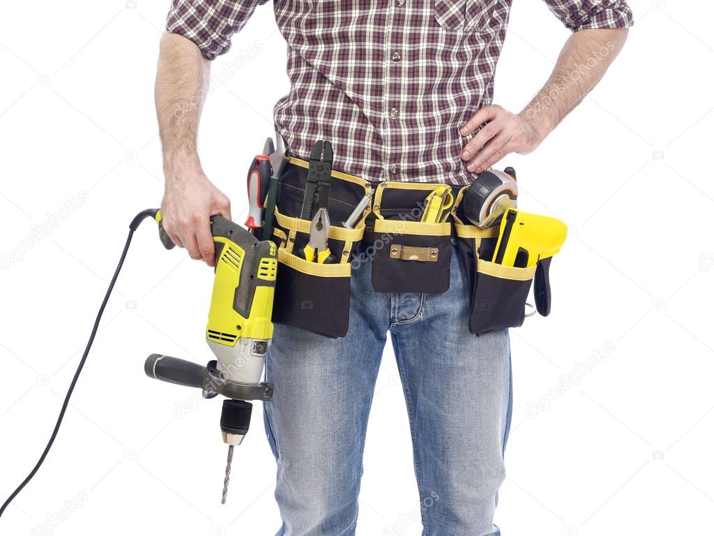 Carpenter with tool belt and drill Stock Photo by ©Goir 104189072