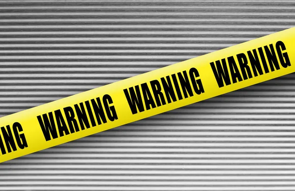 Warning tape on metal — Stock Photo, Image