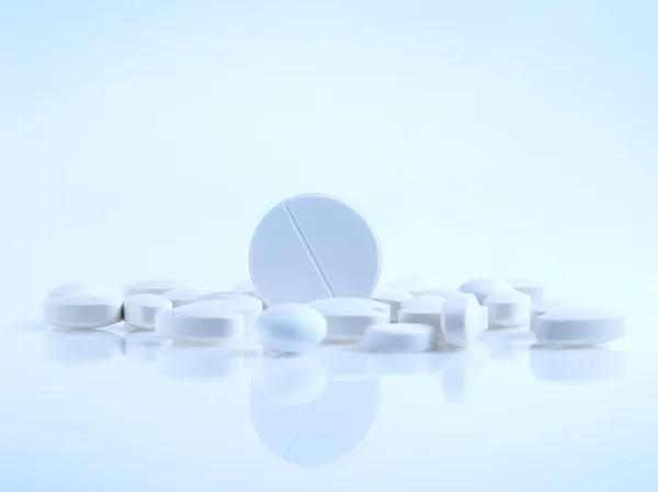 Vitamin pills on blue — Stock Photo, Image