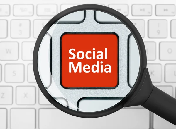 Social media button under the magnifying glass — Stock Photo, Image