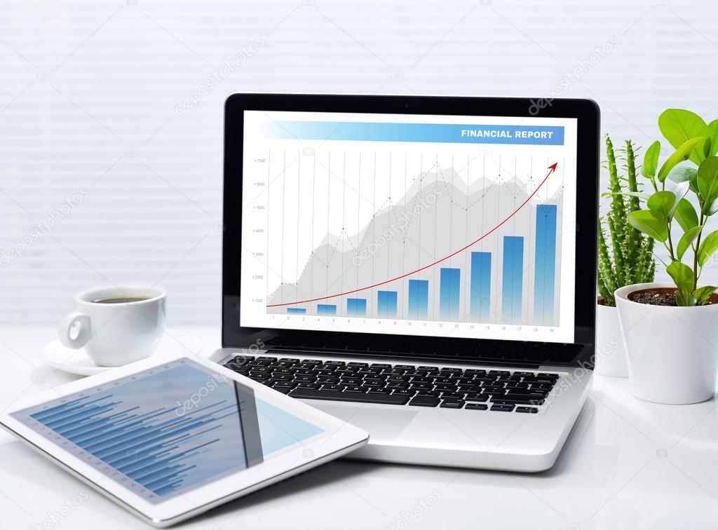 Financial graphs on laptop and tablet