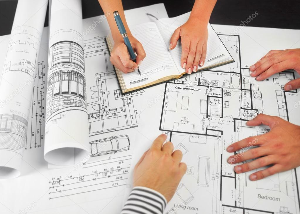 Architects working on blueprints