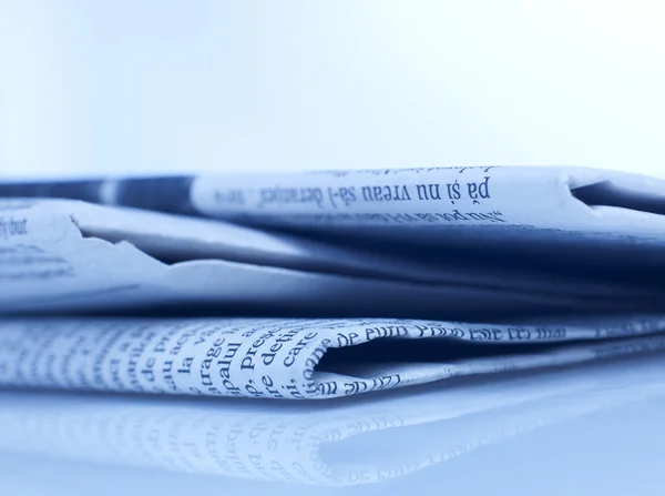 Newspapers close-up on blue — Stock Photo, Image