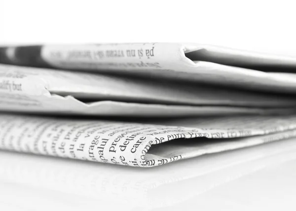 Newspapers close-up on white — Stock Photo, Image