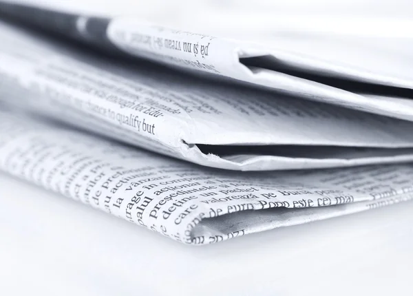 Newspapers on white table — Stock Photo, Image